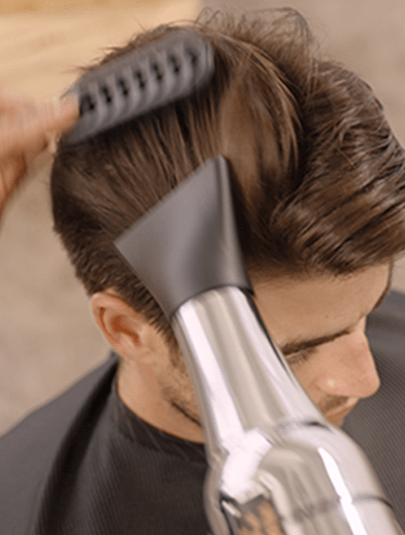 Barber using Wahl Barber Dryer to style and dry hair