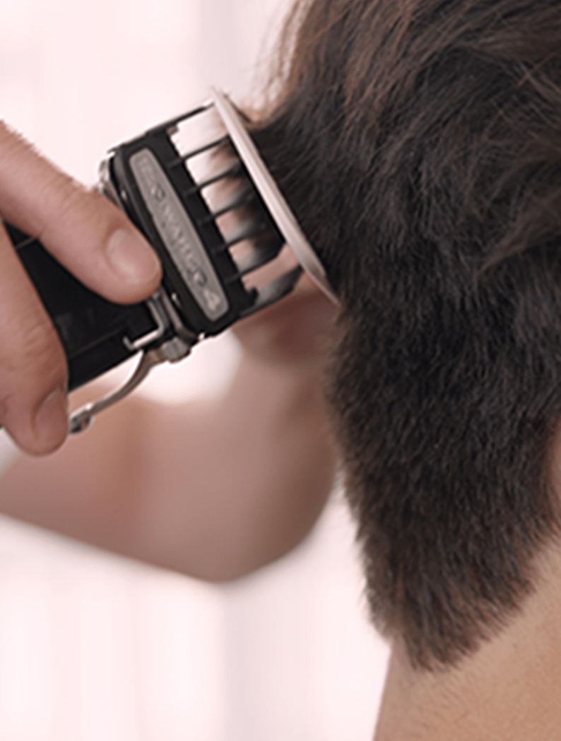 Barber using Wahl Cordless Legend clipper to shape model's hair